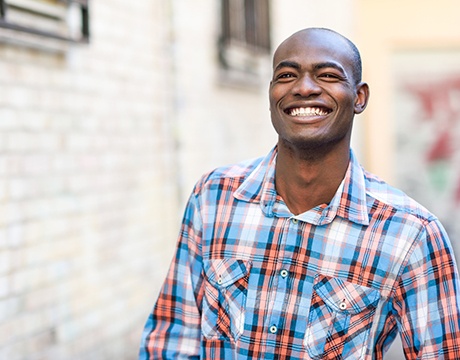 Man smiling after visiting the cosmetic dentist in Gainesville