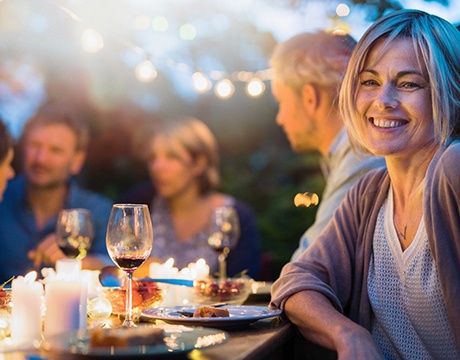 Woman at dinner party with dental bridge in Gainesville