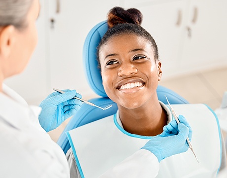 Happy patient looking up at her dentist