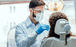 a dentist performing the Chao Pinhole Technique on a patient