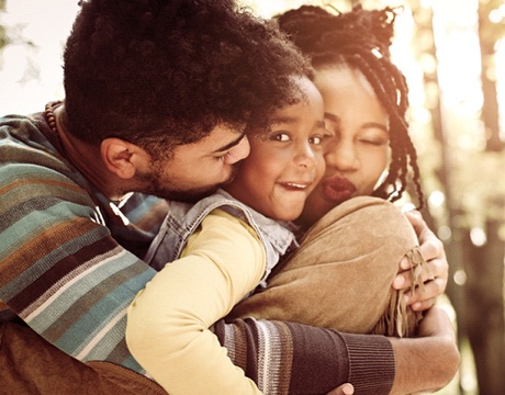 parents hugging their child