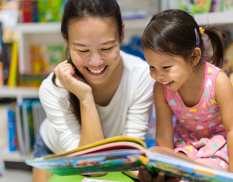 parent reading a book with their child