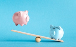 Piggy banks on balance scale