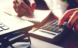 Woman calculating cost of cosmetic dentistry in Gainesville