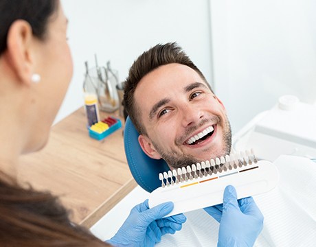 Patient and dentist smiling at each other during appointment