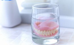 Dentures soaking in a solution