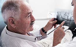 Patient speaking with a denture dentist in Gainesville