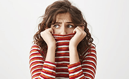 a woman hiding her smile due to tooth loss