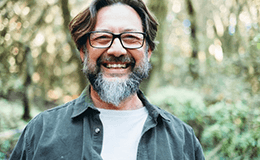 a man smiling after getting dental implants in Gainesville