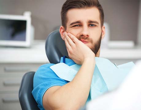 Man with toothache visiting his Gainesville emergency dentist