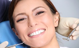 Woman smiling while visiting implant dentist in Gainesville