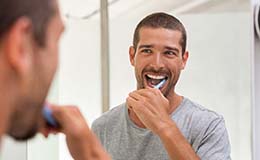 man brushing his teeth