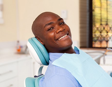 a patient visiting their sedation dentist in Gainesville and smiling