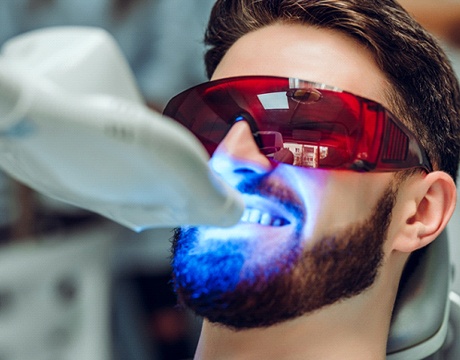 person getting their teeth whitened in a dentist’s office