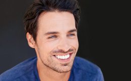 a man smiling after undergoing teeth whitening