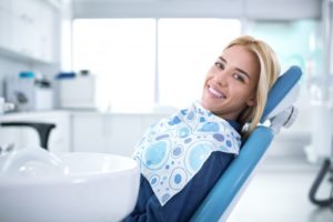 Woman relaxing in dental chair with sedation in Gainesville