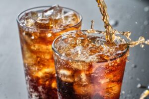 Two glasses of iced soda.