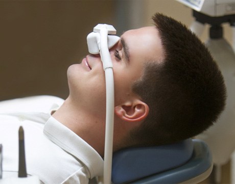 Smiling man using nitrous oxide dental sedation in Gainesville 