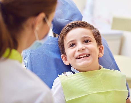 young boy smiles while visiting his Gainesville children’s dentist