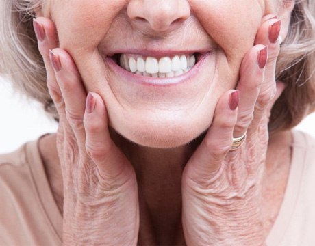 a woman in Gainesville smiling with her new dentures