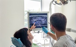 Woman and dentist looking at X-rays